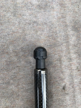 There are small indentions in the socket piece to slip the screw driver in